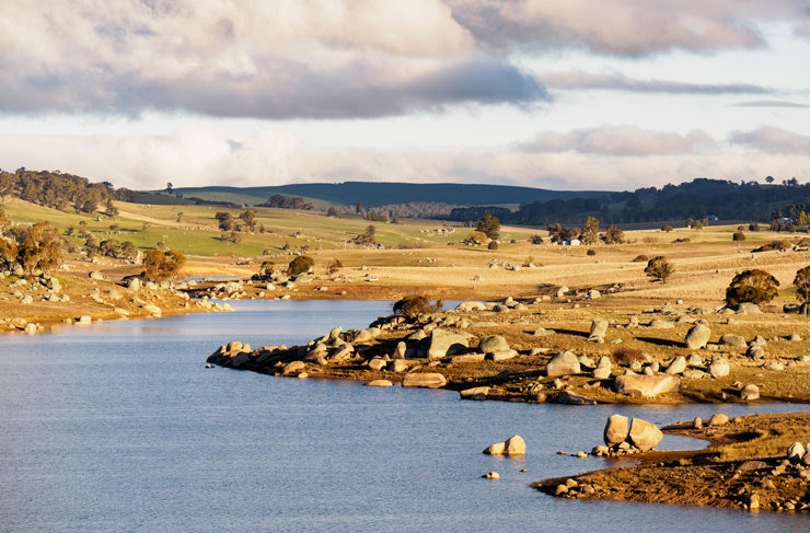 A lake surrounded by rocky green hills. 
