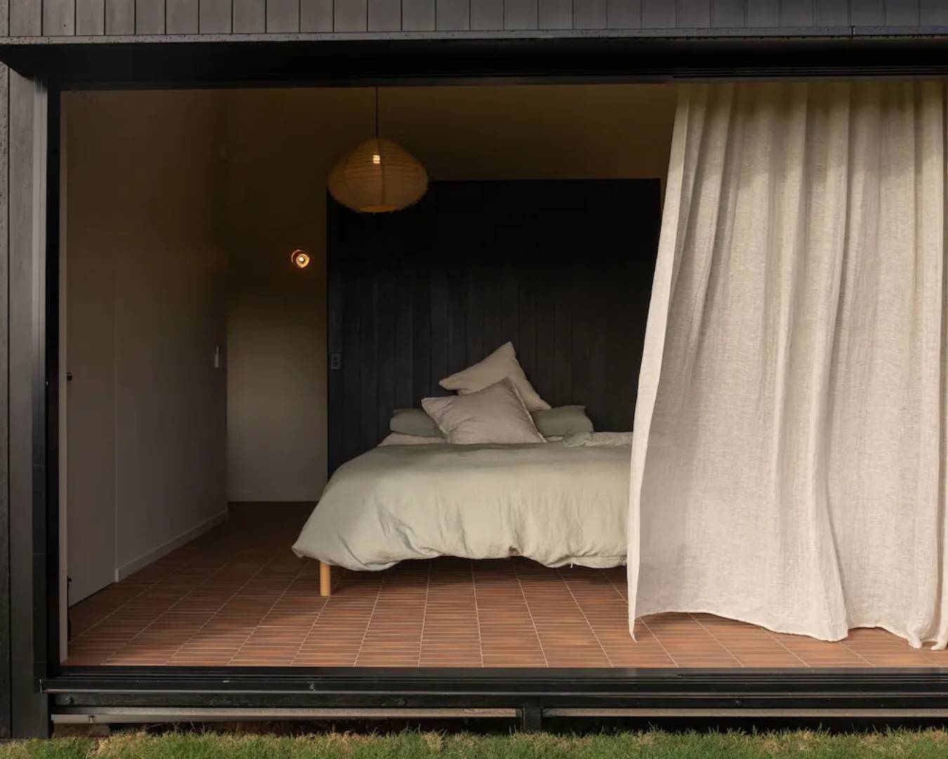 white linen bed spread and bedroom from exterior