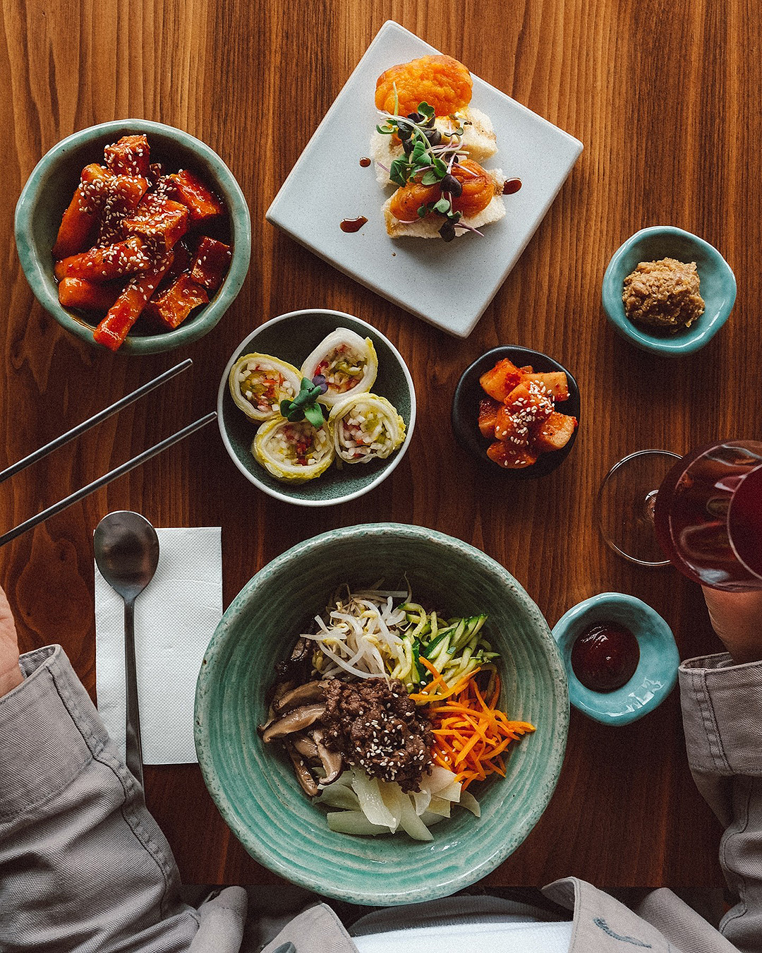 Someone sits down to a selection of dishes at Ockhee on Ponsonby Road.