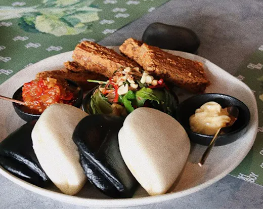 bao buns and fillings on a plate