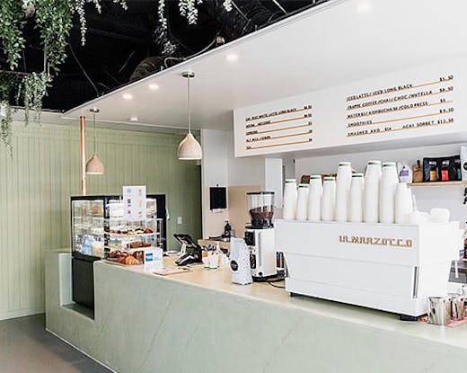 the pastel green interior of a cafe