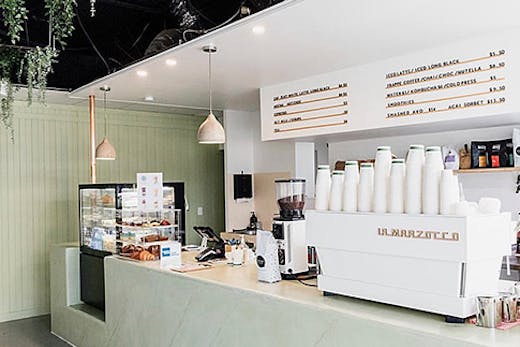 the pastel green interior of a cafe