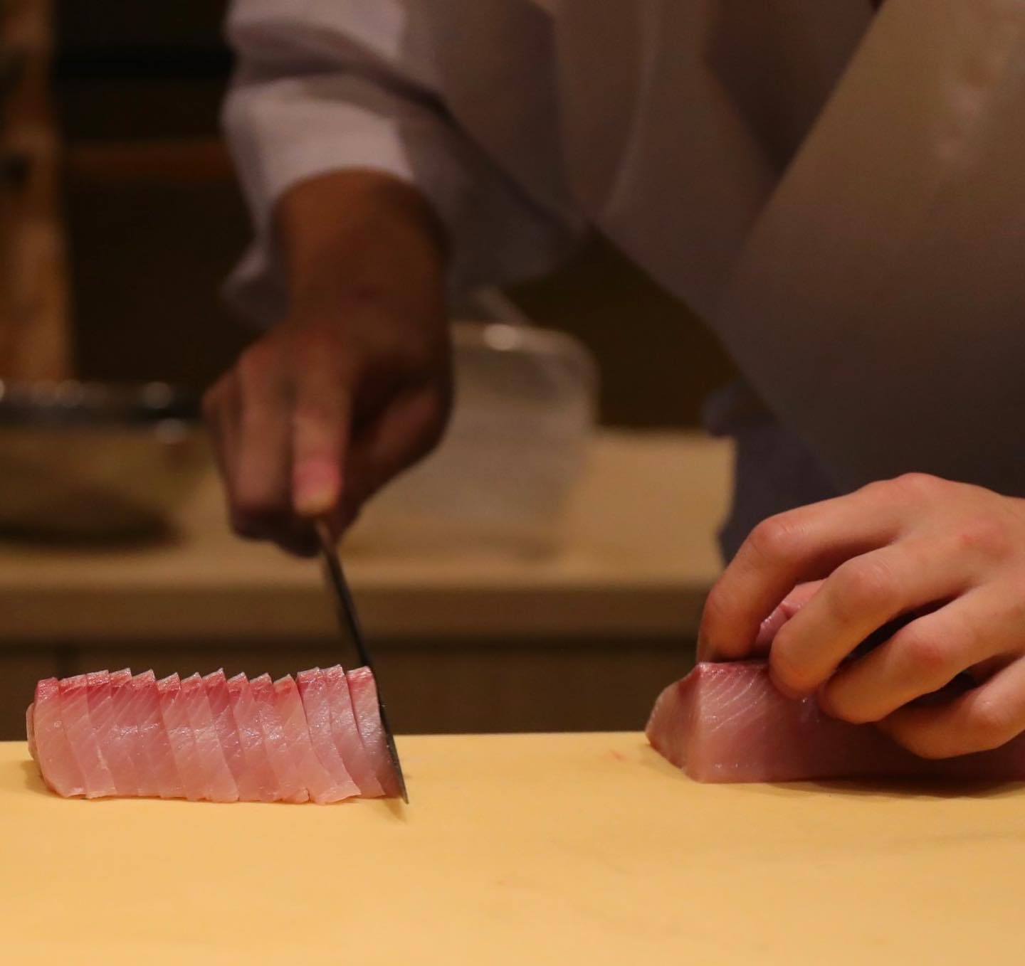 a chef cutting raw fish