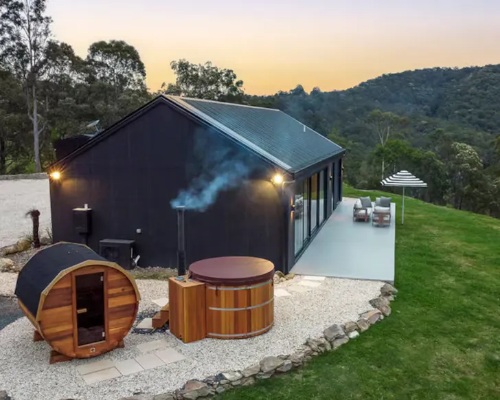 A view of the house, sauna and hot tub at Omina Retreat one of the best NSW Airbnbs