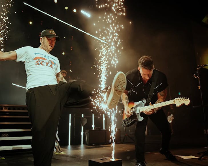 OneRepublic rock out onstageâRyan Tedder kicks through some streaming spacks.