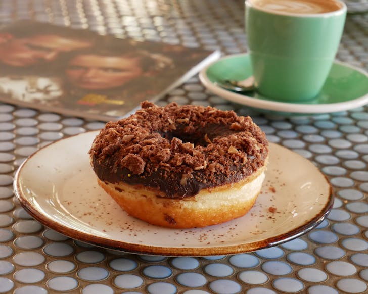 an opera cake donut with chocolate frosting on a tabletop