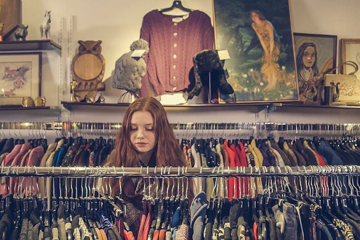 Girl rummaging through racks, best op and vintage shops in Christchurch