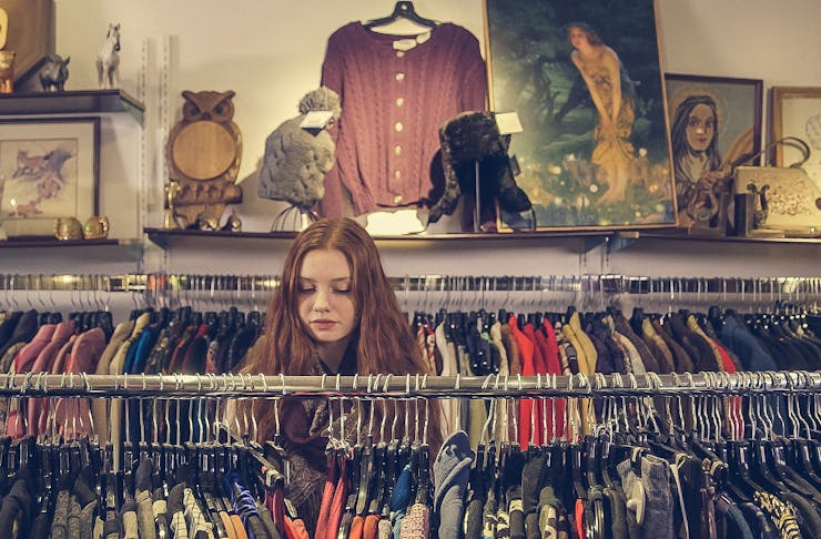 Girl rummaging through racks, best op and vintage shops in Christchurch