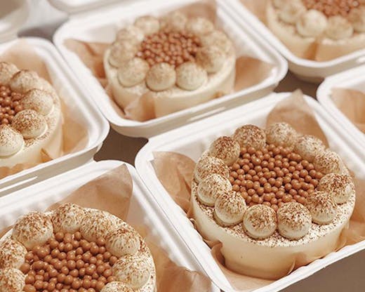 Several baby cakes covered in cream.