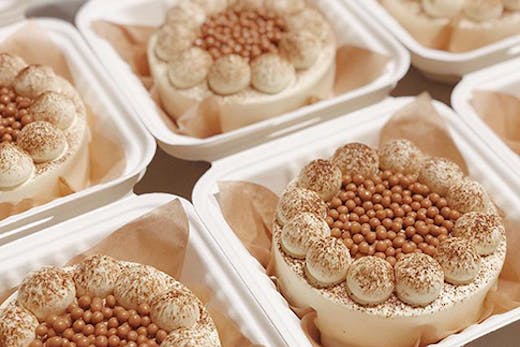 Several baby cakes covered in cream.