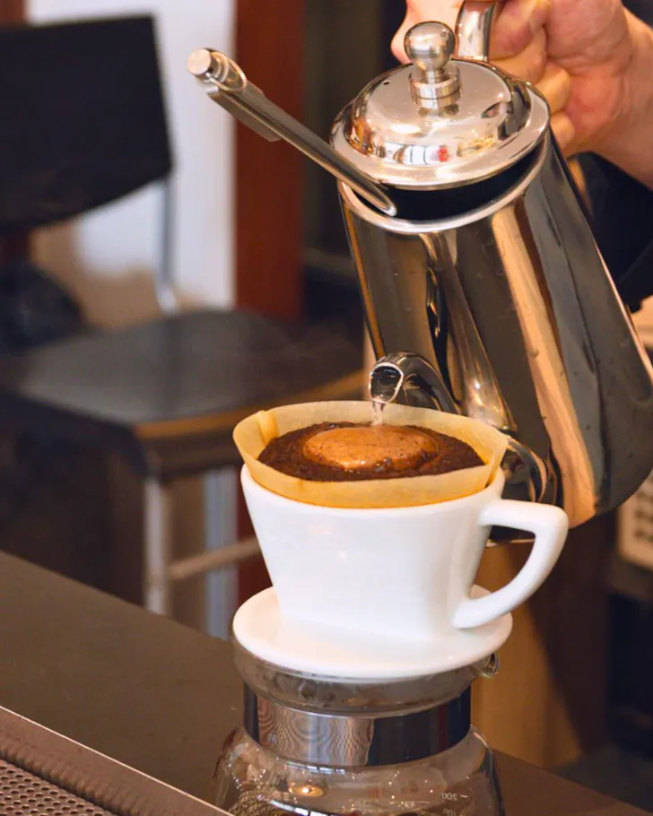 A close-up of drip coffee being poured in Osaka specialty coffee shop.