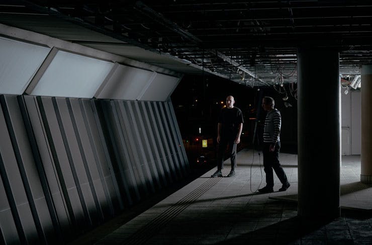 Artists installing sound and lighting at an abandoned monorail station in Sydney. 