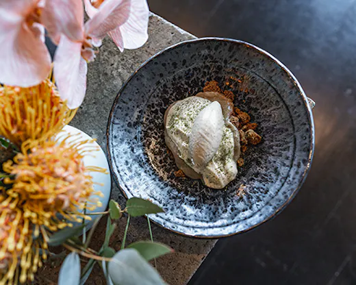 A decadent strawberry gum ice cream surrounded by flowers.