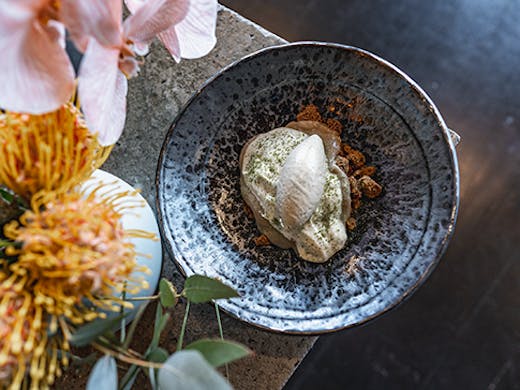 A decadent strawberry gum ice cream surrounded by flowers.