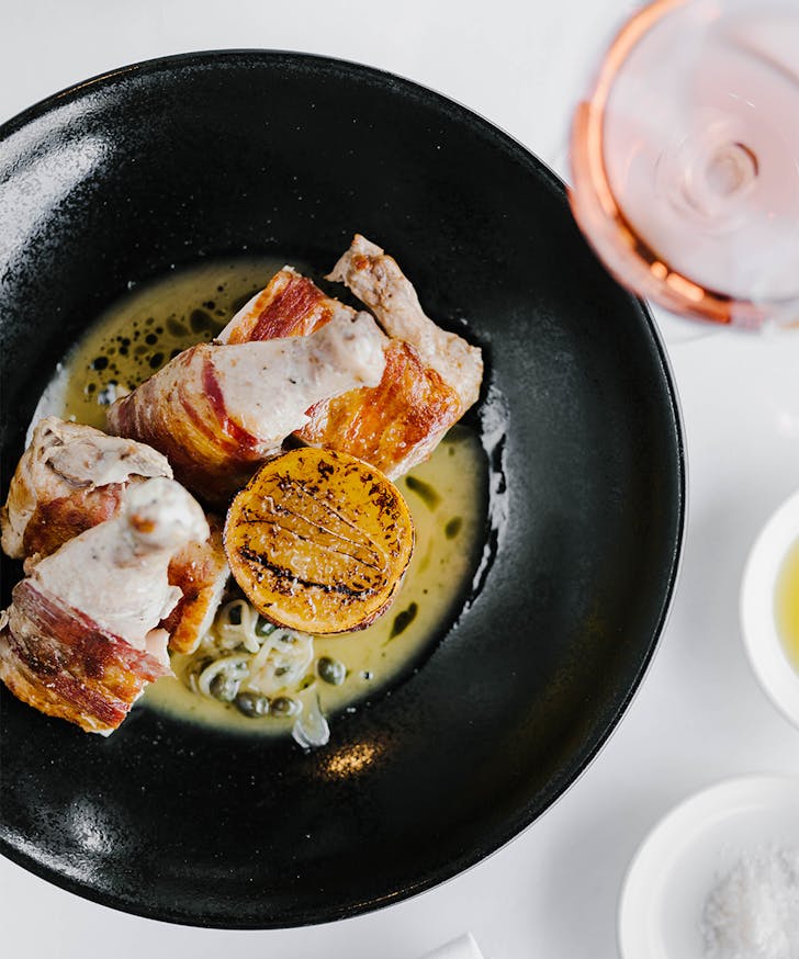 spatchcock dish and a glass of wine