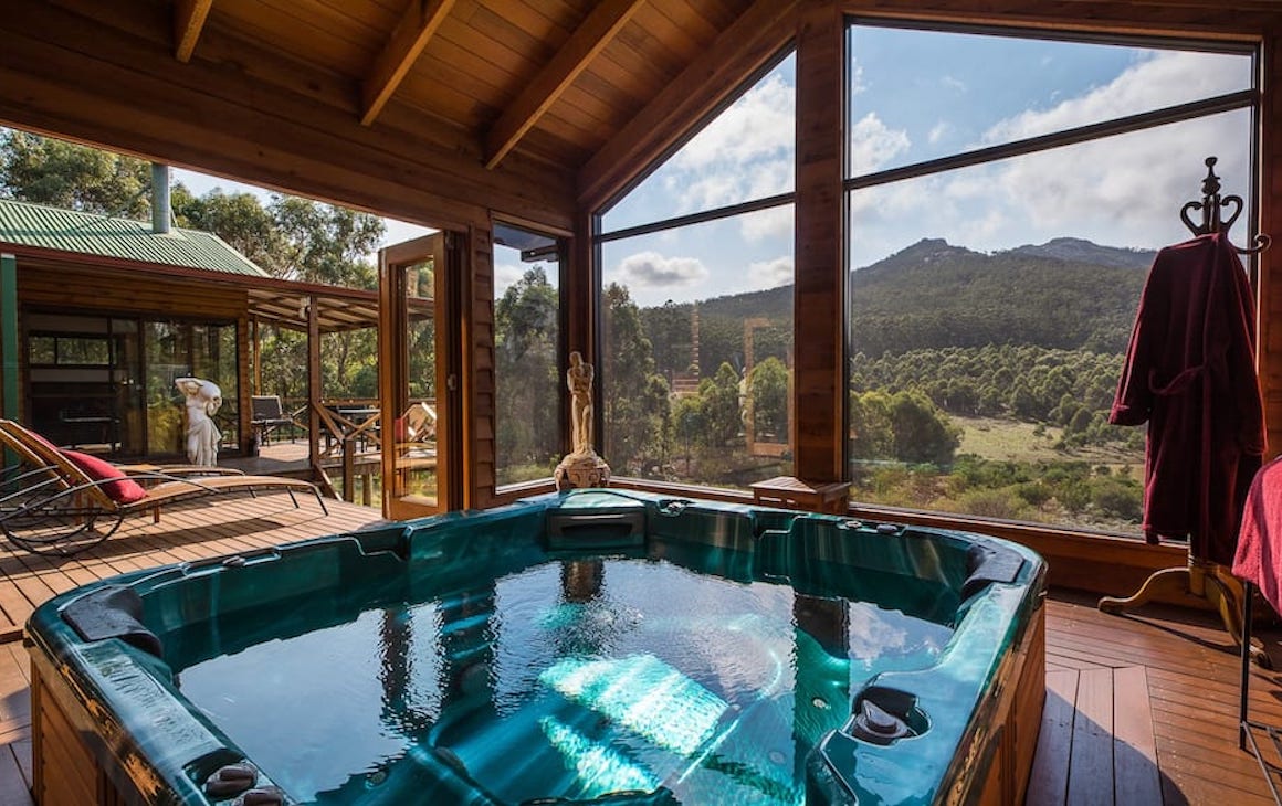 A large jacuzzi overlooking rolling hills