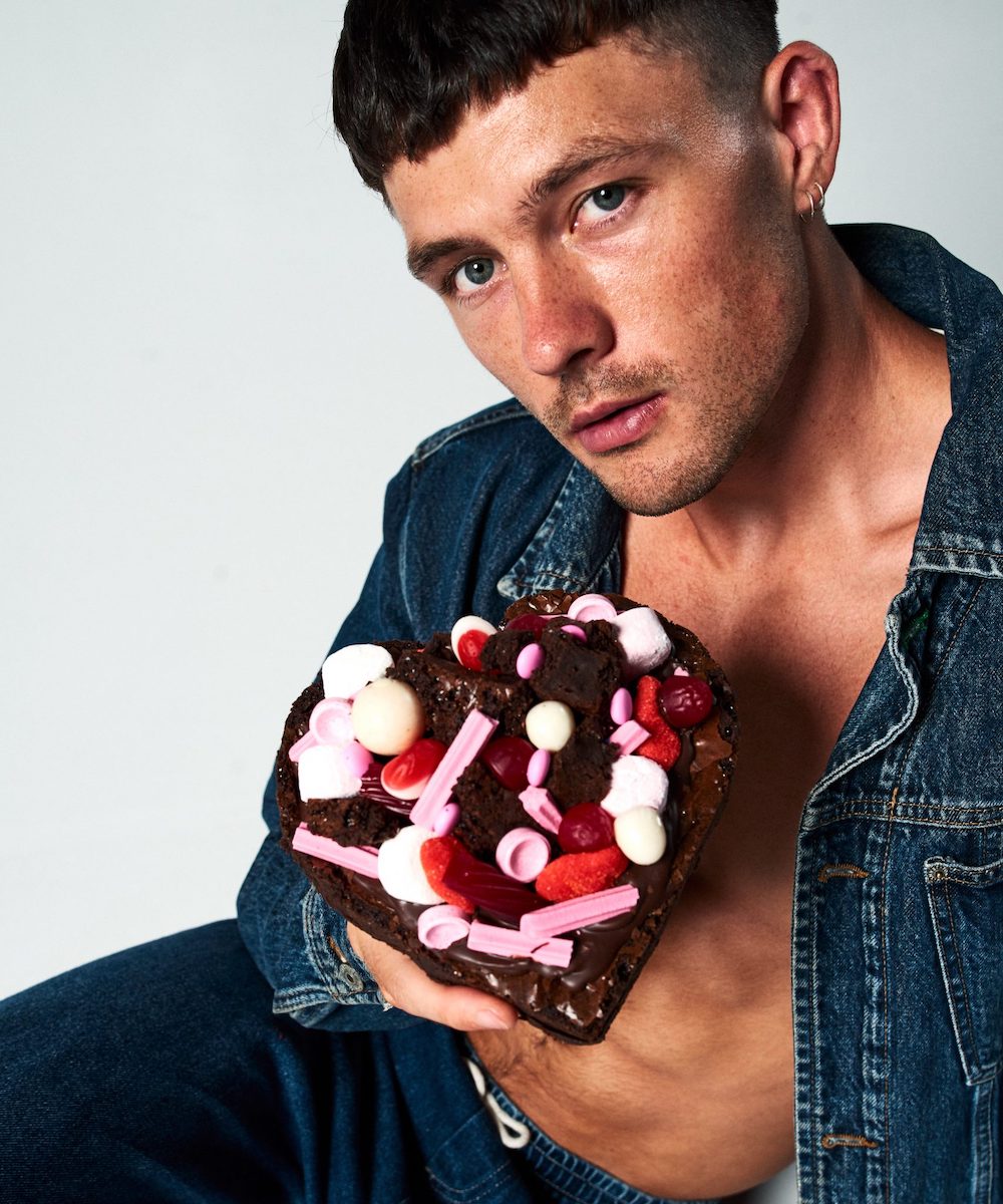 a male model holding a chocolate candy heart