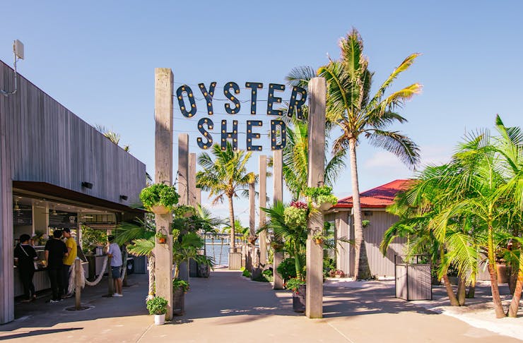 Entrance to the Oyster Shed, with the name in large letters atop a wooden entry way