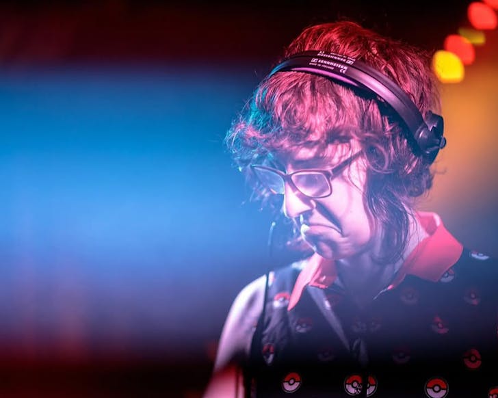 Close-up shot of Paige Julia with a bass face as she DJs.