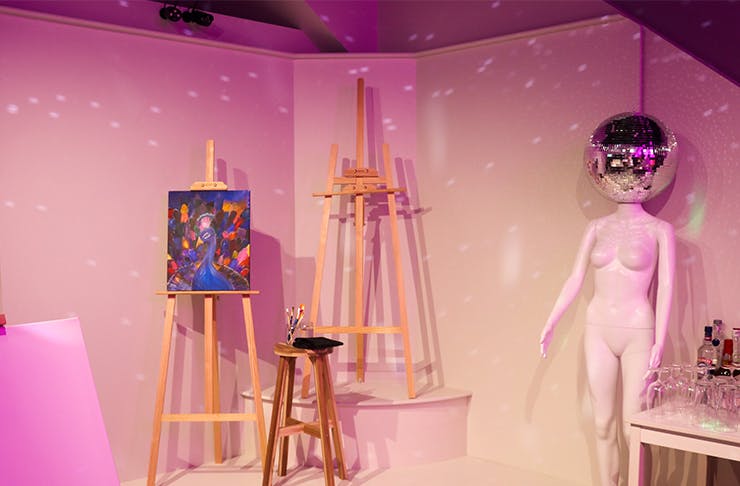 three easels and a mannequin with a disco head