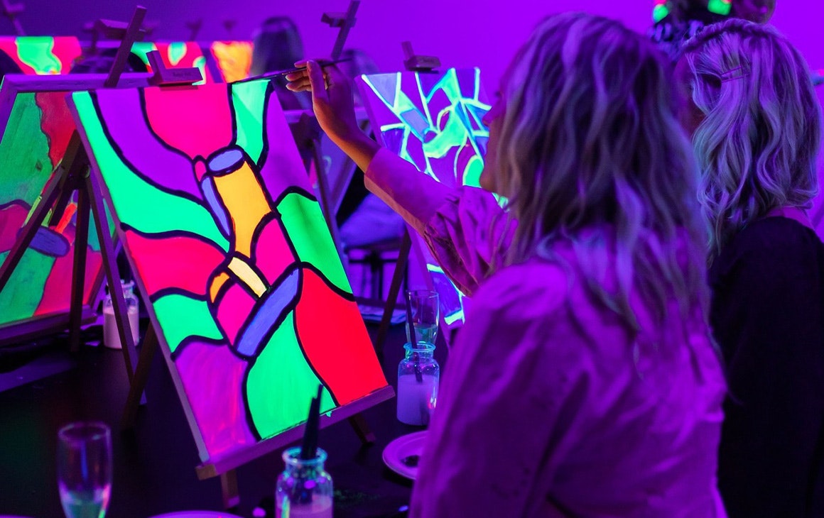 people painting under uv lights