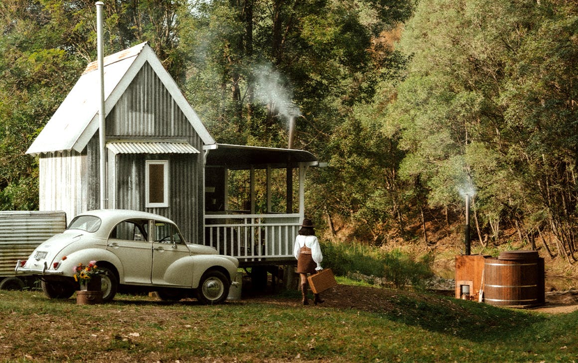 A tiny house with a hot tub in front of it