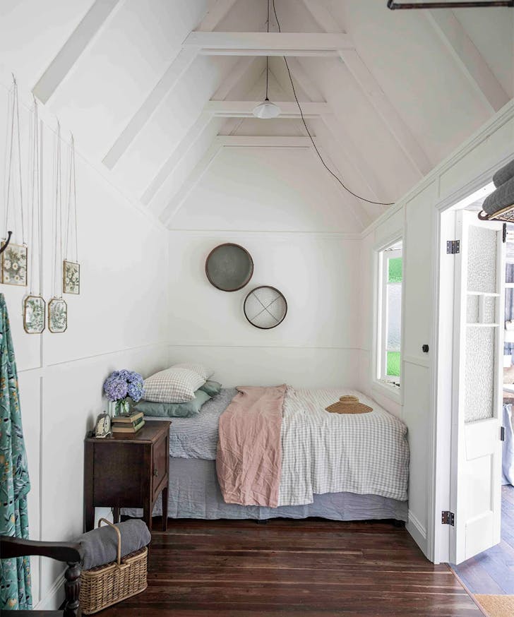 bed against a wall in a small cabin