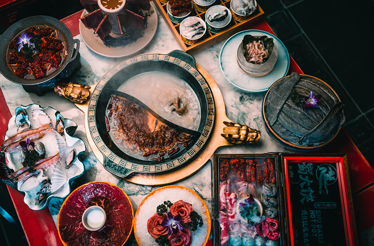 A table with different dishes and some of the best hot pot in Melbourne. 