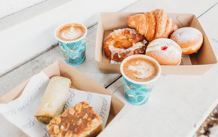 Baked goods in a box with coffee