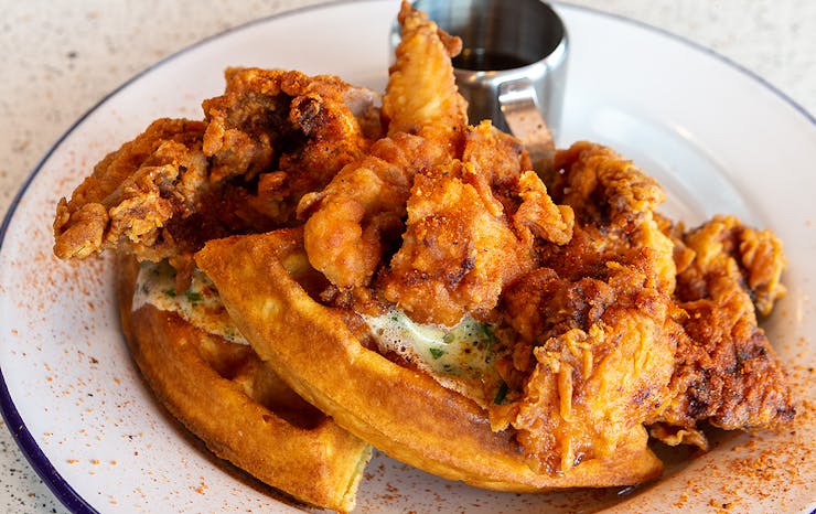 A delicious looking dish of chicken and waffles from Peach's hot chicken, one of Auckland's best American food diners