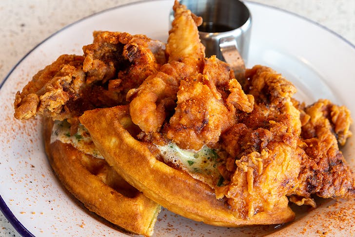 A delicious looking dish of chicken and waffles from Peach's hot chicken, one of Auckland's best American food diners