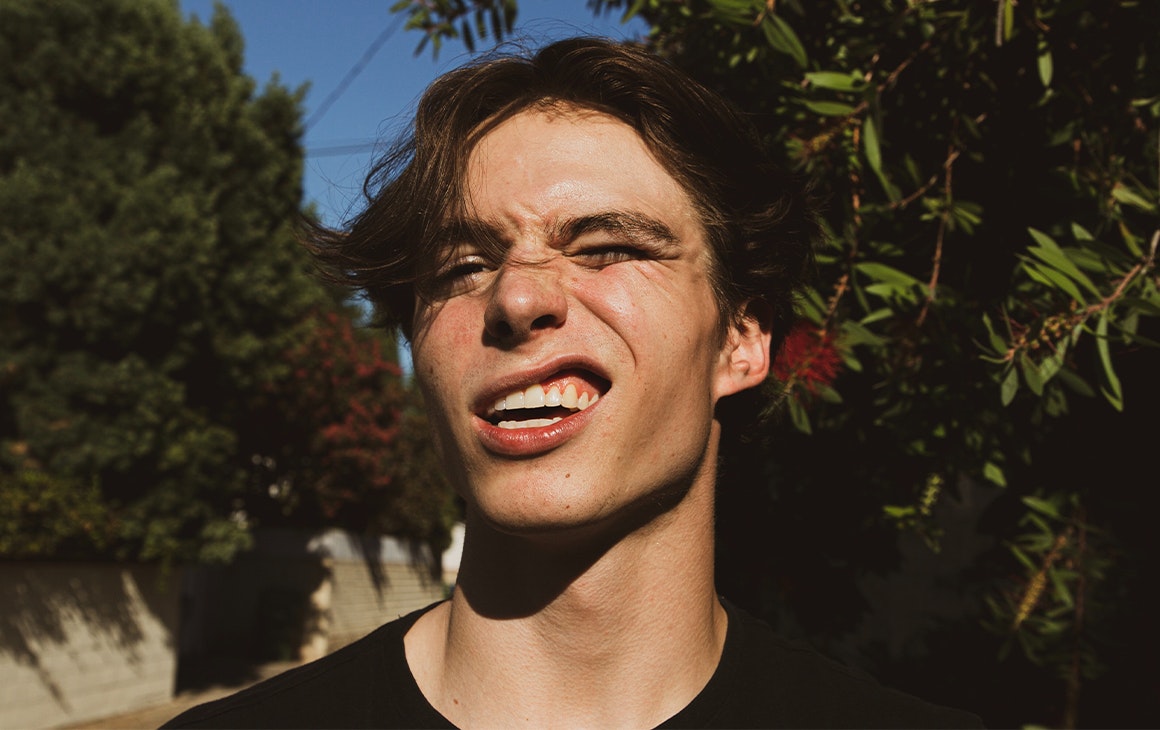 a man outside smiling