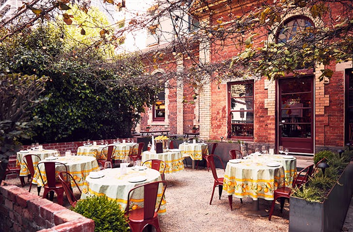 A piazza with classice Italian tables set up.