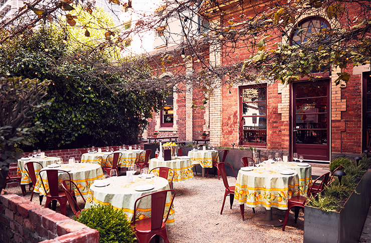 A piazza with classice Italian tables set up.