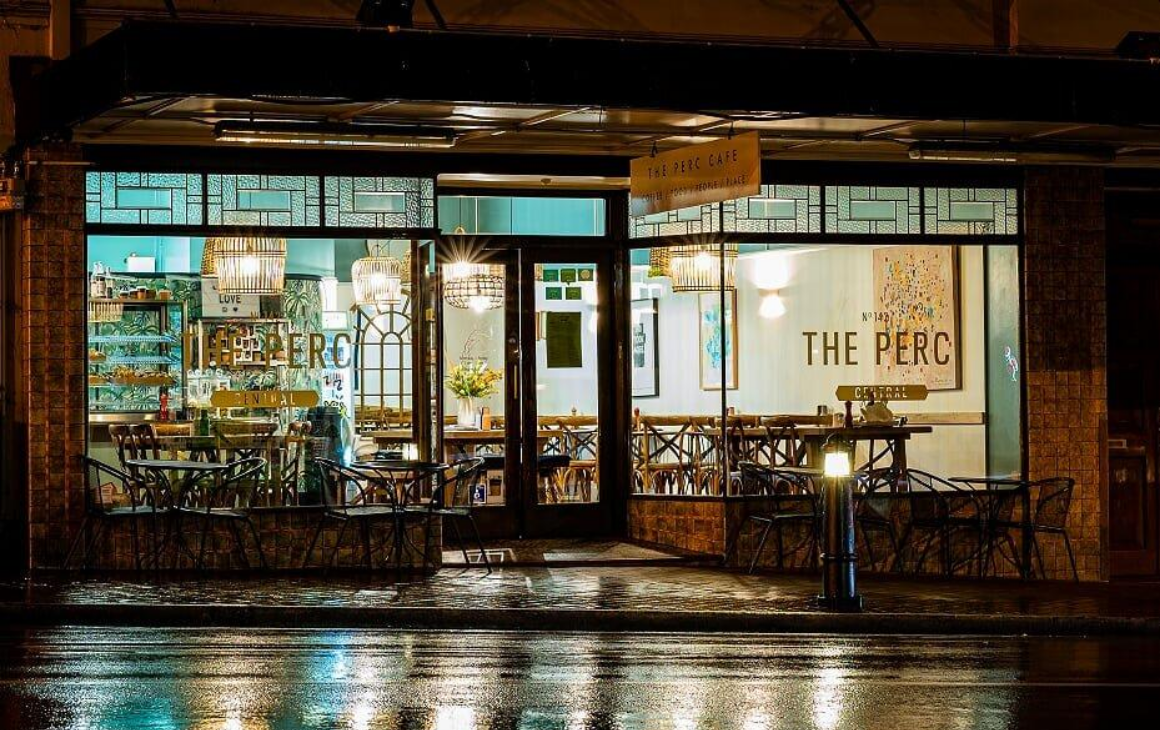 The Perc Cafe shining in moonlight and freshly rained pavement