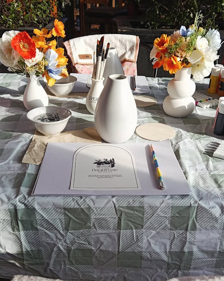 All the materias are ready, laid out on a sunny table for a Petal & Posie vase sip and paint session.