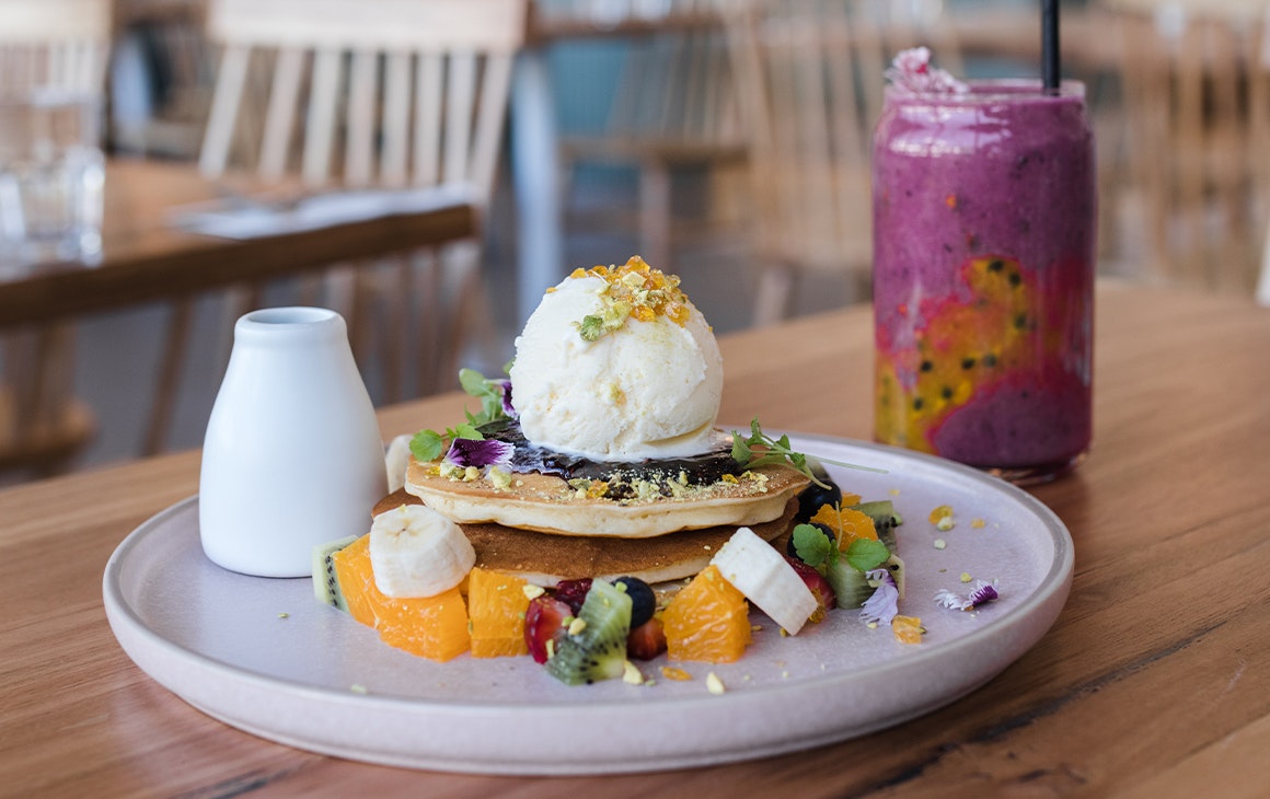 a plate of pancakes and a smoothie