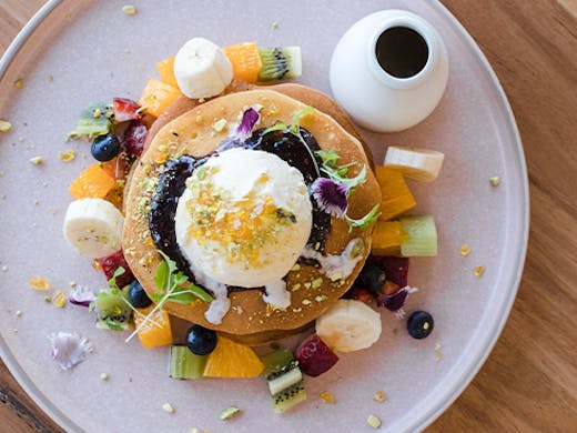 pancakes topped with fruit and ice cream