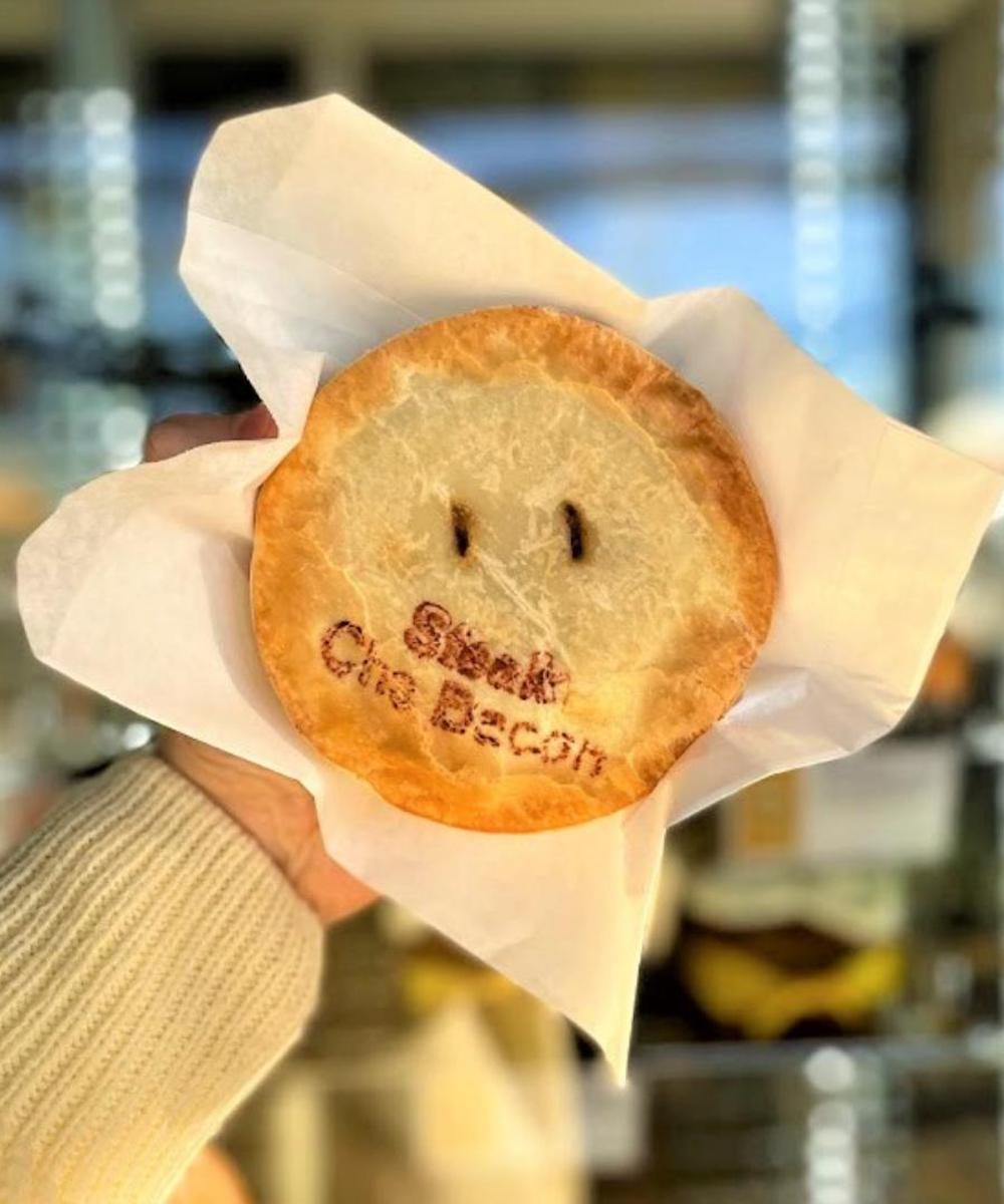 Hand holding a pie from Miami Bakehouse