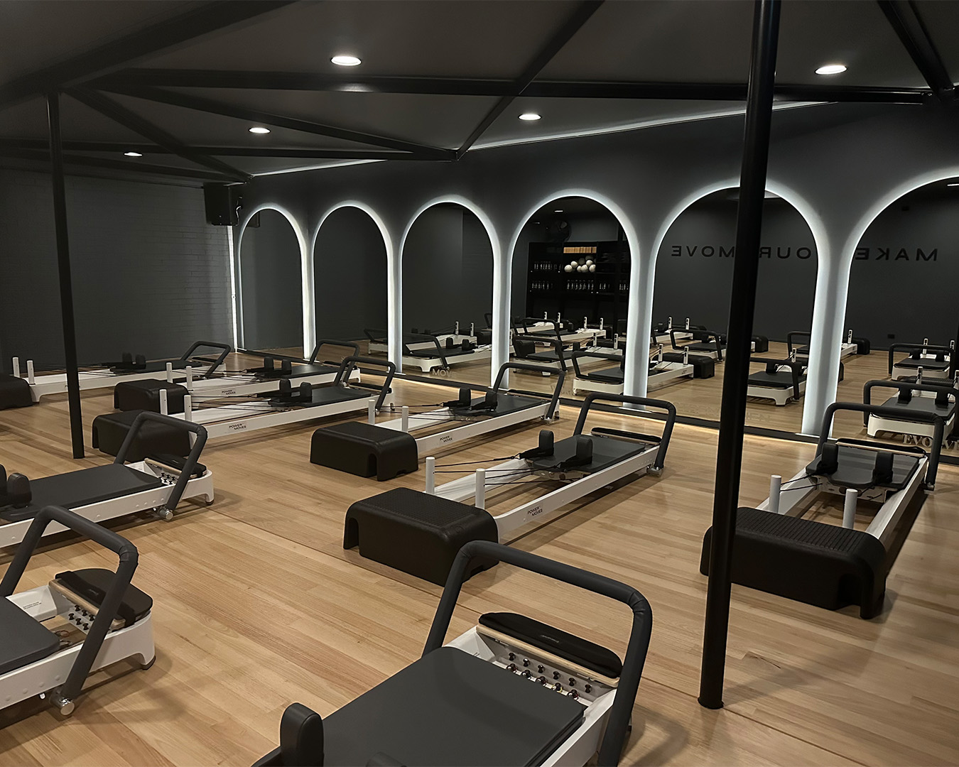 a brisbane pilates studio with reformer beds and curved mirrors