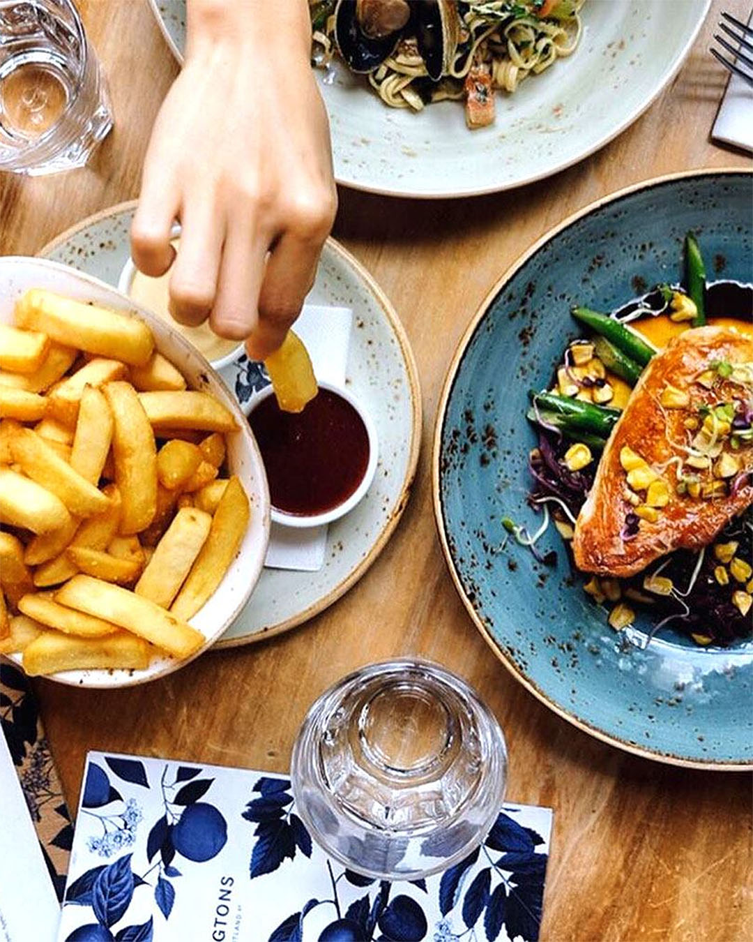 Someone grabs a chip from a table filled with food at Pilkington's bottomless and long lunch.