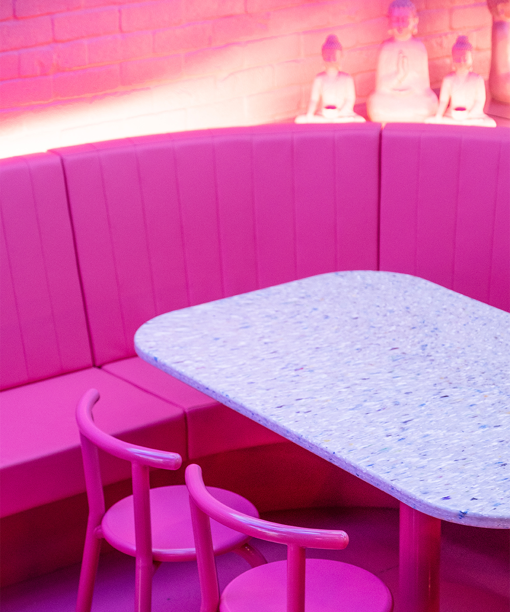 a corner in an all pink restaurant interior.