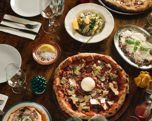 Pippo's Pizza and dishes laid on the dining table