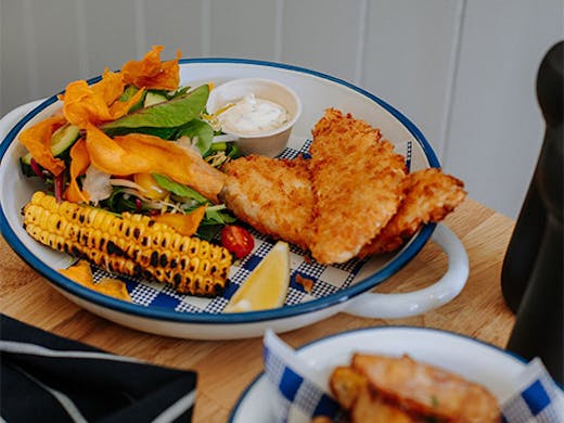a plate of fish, chips and salad