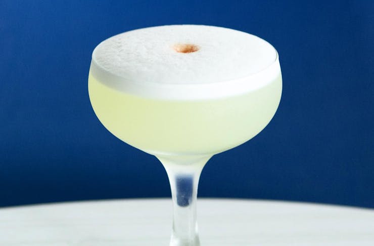 A Pisco Sour cocktail served in a coupe glass. 