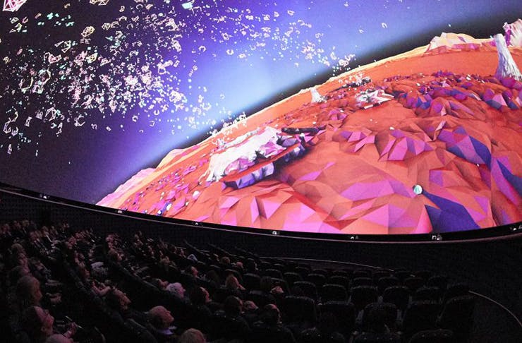 People in a fulldome cinema.