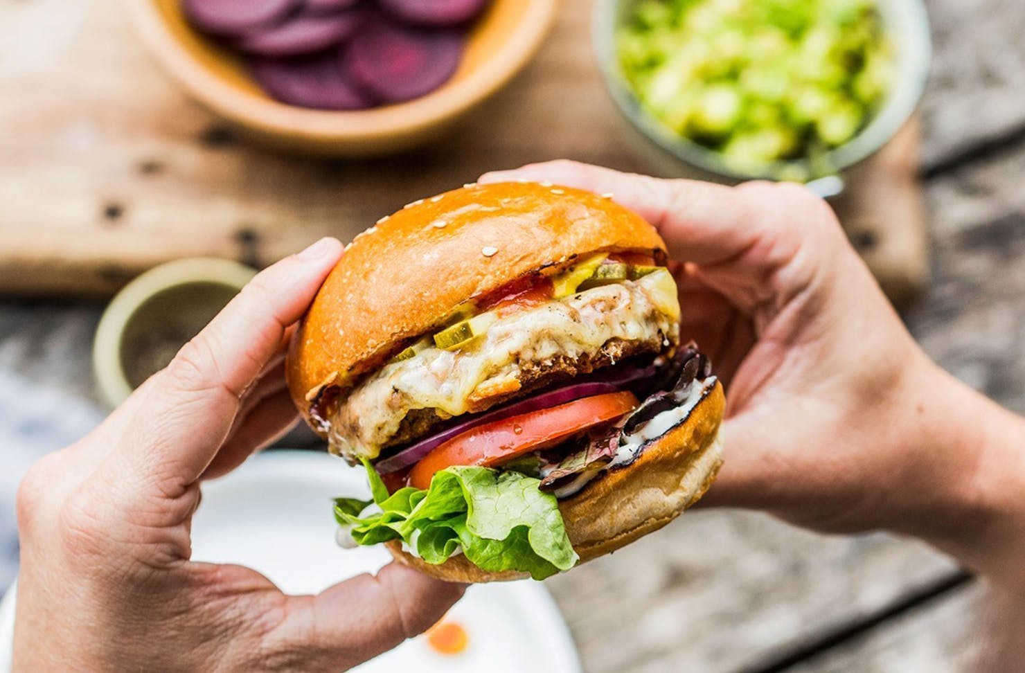 Person holding a plant-based burger.