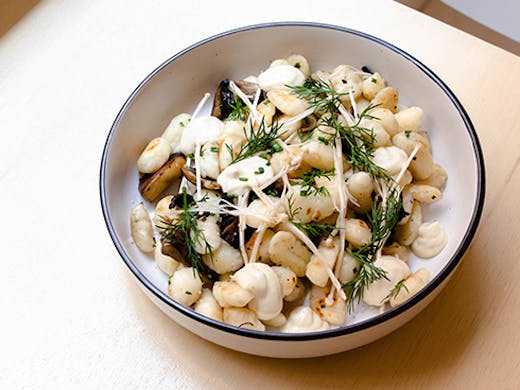 a bowl of vegan gnocchi with mushrooms