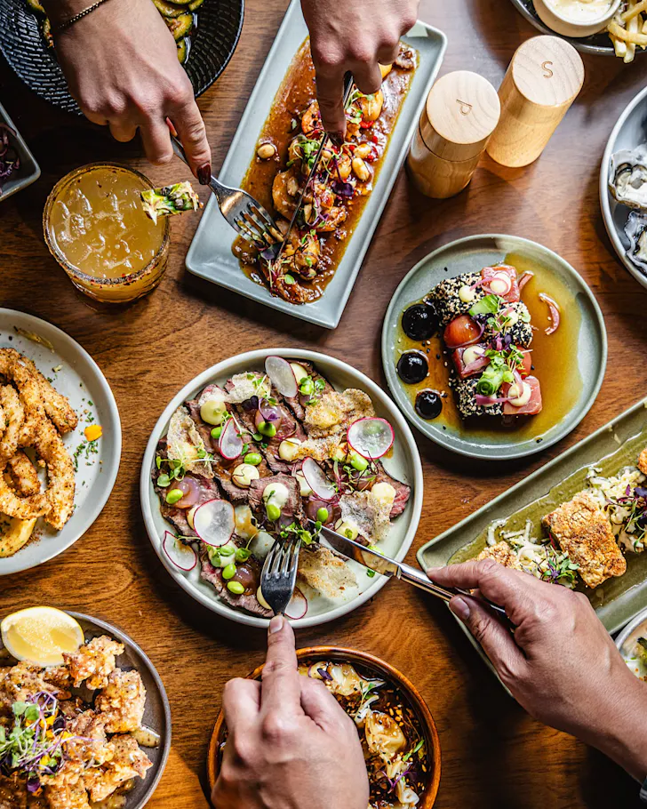 People dig into a feast at Plateau Bar and Eatery.