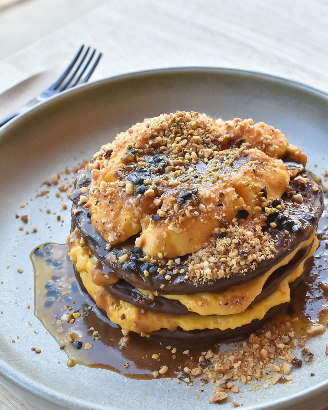 a stack of pancakes with pumpkin cream between each pancake